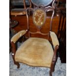 A VICTORIAN MAHOGANY ARM CHAIR, A BUTTONED OVAL BELOW THE SEPENTINE TOP RAIL, THE SERPENTINE FRONTED