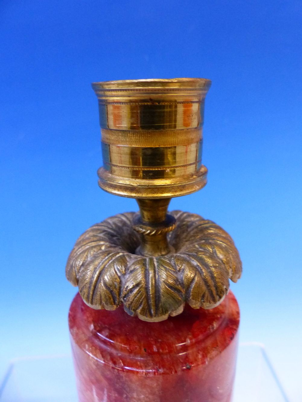 A 19th C. ORMOLU CANDLESTICK WITH FOLIATE DRIP PAN ABOVE A RED CRYSTALLINE CYLINDRICAL BASE. H 14. - Image 5 of 12