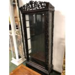 A 19th C. CHINESE HARD WOOD DISPLAY CABINET, THE GLAZED DOOR AND SIDES FLANKED BY GRAPE VINES CARVED