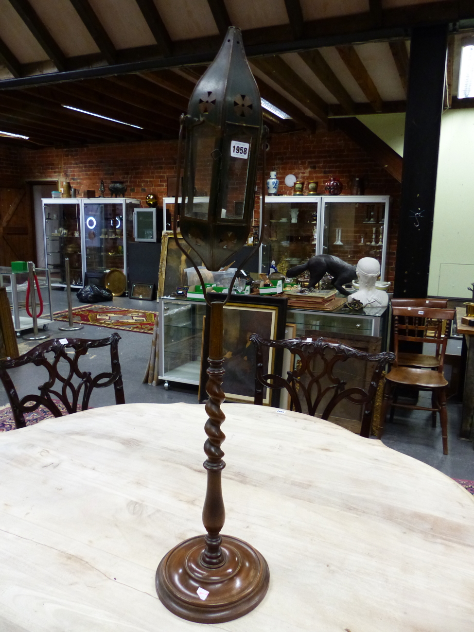 A 19th C. GLAZED TOLE CANDLE LANTERN RAISED ON SPIRAL TURNED WOOD COLUMN AND DISHED CIRCULAR FOOT. H