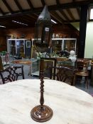 A 19th C. GLAZED TOLE CANDLE LANTERN RAISED ON SPIRAL TURNED WOOD COLUMN AND DISHED CIRCULAR FOOT. H