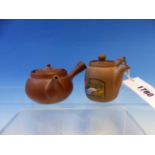 TWO CHINESE YIXING TEA POTS BOTH WITH HANDLES PIERCED WITH CASH MEDALLIONS, ONE PAINTED WITH FAMILLE