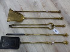 A SET OF THREE 19th C. BRASS FIRE IRONS TOGETHER WITH AN EARLIER BRASS AND IRON SHOVEL AND