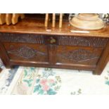 AN ANTIQUE OAK COFFER THE TWO PANELS TO THE FRONT CARVED WITH ROSETTE CENTRED DIAMONDS. W 104 x D
