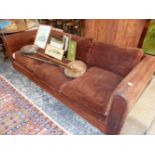 A BROWN SUEDE UPHOLSTERED THREE SEAT SETTEE. W 233cms.