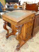 A 19th C. WALNUT DAVENPORT WITH LEATHER INSET SLOPING LID AND FOUR DRAWERS TO ONE SIDE BEHIND
