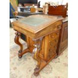 A 19th C. WALNUT DAVENPORT WITH LEATHER INSET SLOPING LID AND FOUR DRAWERS TO ONE SIDE BEHIND