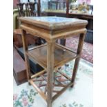 A CHINESE BLUE AND WHITE PORCELAIN INSET TWO TIER TABLE, THE APRON CARVED WITH BATS, THE SQUARE LEGS