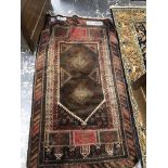 A BELOUCH PRAYER RUG. 145 x 83cms. TOGETHER WITH A MACHINE MADE RUG OF PERSIAN HUNTING DESIGN. 190 x