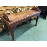 A 19th C. MAHOGANY DOUBLE STOOL WITH HALF ROUND HANDLES TO EACH NARROW END, THE SQUARE SECTIONED LEG