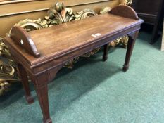 A 19th C. MAHOGANY DOUBLE STOOL WITH HALF ROUND HANDLES TO EACH NARROW END, THE SQUARE SECTIONED LEG