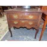 AN 18th C. AND LATER OAK LOWBOY WITH TWO SHORT AND A LONG DRAWER ABOVE THE SHAPED APRON AND CABRIOL