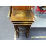 AN ANTIQUE NEST OF THREE HAND PAINTED OCCASIONAL TABLES.