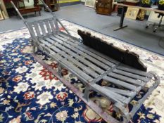 A GREY PAINTED WOOD DOG DRAWN SLEDGE WITH HANDLES TO ONE END OF THE OPEN PLANKED TOP ABOVE RED RUNN