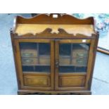 A LATE VICTORIAN OAK TABLE TOP CABINET WITH GALLERIED TOP OVER GLAZED DOORS ENCLOSING PIGEON HOLES