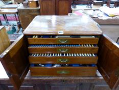 AN ANTIQUE WALNUT CASED CANTEEN CONTAINING AN EXTENSIVE SILVER PLATED CUTLERY SET.