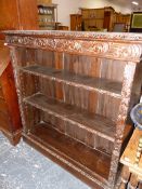 A FOLIATE CARVED OAK OPEN BOOKCASE WITH TWO ADJUSTABLE SHELVES. W 106 x D 31 x H 112cms.