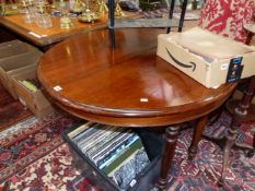 A 19th C. MAHOGANY DINING TABLE, THE DEMILUNE ENDS EXTENDING TO TAKE A LEAF, THE BUN TURNED