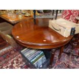 A 19th C. MAHOGANY DINING TABLE, THE DEMILUNE ENDS EXTENDING TO TAKE A LEAF, THE BUN TURNED