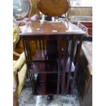 AN EARLY 20th CENTURY MAHOGANY ROTARY BOOKCASE, THE SQUARE TOP OVER TWO TIERS OF SHELVES. W 46.5 x D