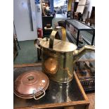 A BRASS HOT WATER CAN. H 39cms. TOGETHER WITH A COPPER BUN SHAPED WARMING VESSEL. Dia. 25cms.