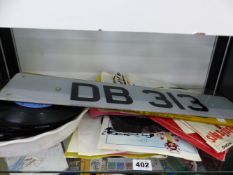 A SMALL COLLECTION OF RECORD SINGLES AND A PAIR OF LICENCE PLATES DB 313( NOT REGISTRATION)