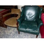 A GREEN LEATHER UPHOLSTERED WING ARM CHAIR ON SQUARE SECTION MAHOGANY LEGS WITH CASTER FEET