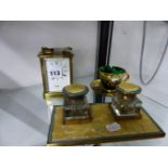 A VINTAGE BRASS CASED CARRIAGE CLOCK WITH ALARM, A DESK STAND, AND AN ENAMELLED GLASS CUP AND