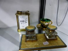 A VINTAGE BRASS CASED CARRIAGE CLOCK WITH ALARM, A DESK STAND, AND AN ENAMELLED GLASS CUP AND