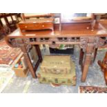 A CHINESE HARD WOOD ALTAR TABLE, THE ROLL OVER NARROW ENDS PIERCED WITH CHAIN MOULDINGS, THE APRON