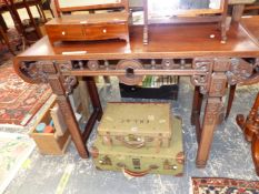 A CHINESE HARD WOOD ALTAR TABLE, THE ROLL OVER NARROW ENDS PIERCED WITH CHAIN MOULDINGS, THE APRON