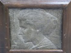 A FRAMED METAL RELIEF PROFILE OF A LADY DATED 1913 AND SIGNED M V M CARR?. 26 x