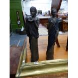 A PAIR OF AFRICAN FIGURES AND AN ANTIQUE BRASS FENDER.