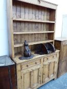 A 19th C. PINE DRESSER, THE ENCLOSED THREE SHELF BACK ABOVE A TWO DRAWER AND TWO DOOR BASE. W 126