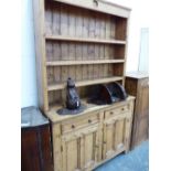 A 19th C. PINE DRESSER, THE ENCLOSED THREE SHELF BACK ABOVE A TWO DRAWER AND TWO DOOR BASE. W 126