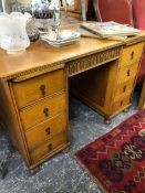 A SMALL OAK PEDESTAL DESK. W 114 X D 67 X H 78cms.