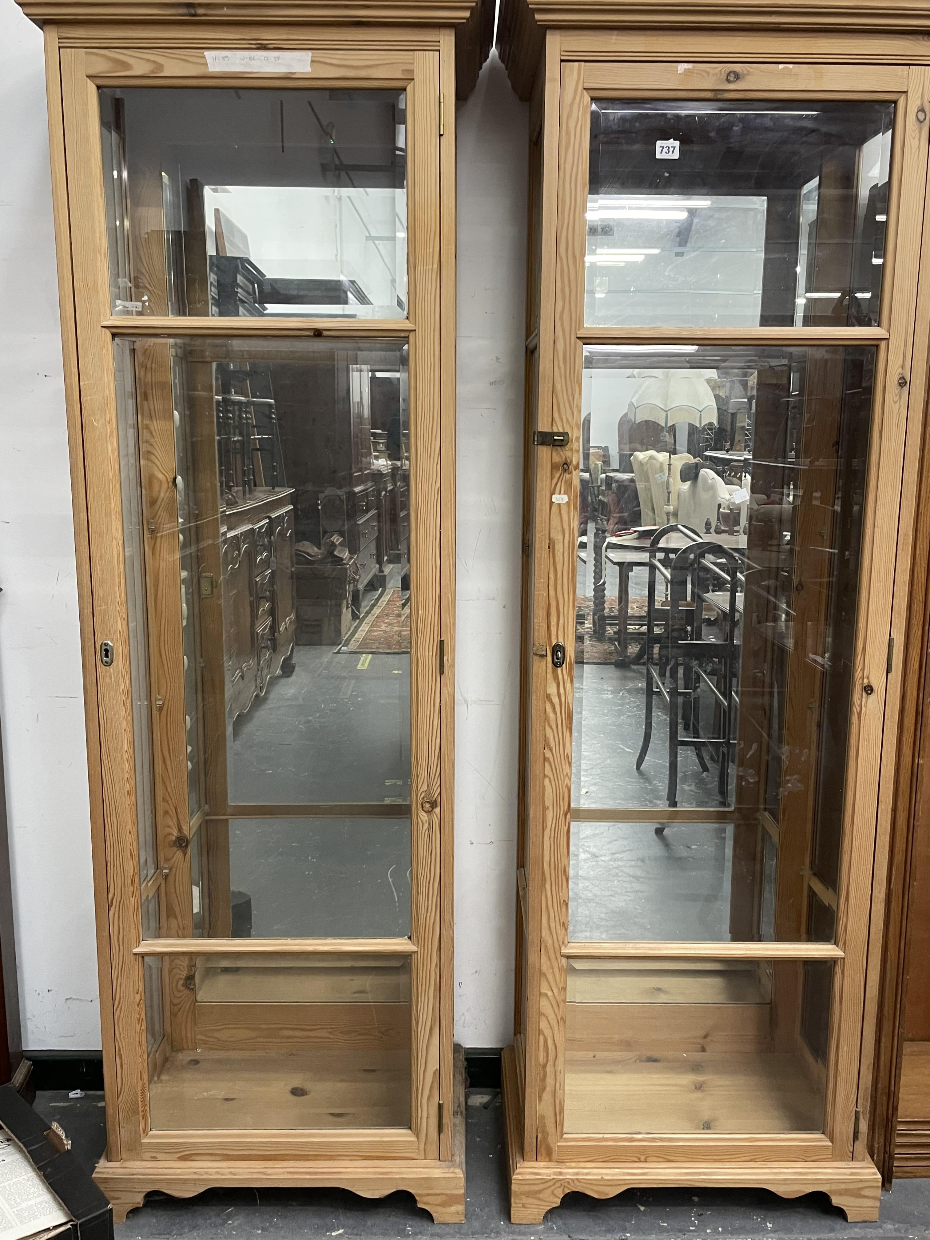 A PAIR OF PINE FRAMED GLAZED DISPLAY CABINETS. EACH MEASURING W 66 X D 38 X H 185cms.