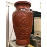 A CHINESE RED WARE VASE MOULDED IN RELIEF WITH A SAGE BOATING BELOW A WILLOW TREE, SEAL MARK. H 36.