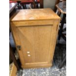 A PALE OAK BEDSIDE CABINET.