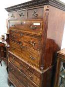 A GEORGIAN MAHOGANY CROSS BANDED CHEST ON CHEST WITH BRUSHING SLIDE. W 106 X D 54 X H 187cms.