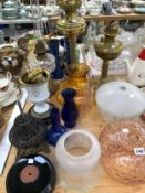 FOUR OIL LAMPS AND VARIOUS SHADES
