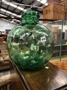 A LARGE GREEN GLASS JAR.