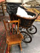 A DOLLS PRAM AND ROCKING CHAIR.