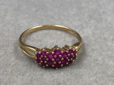 A HALLMARKED 9ct GOLD RUBY MULTI CLUSTER DRESS RING. FINGER SIZE T. WEIGHT 1.5grms.