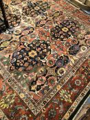 (g) A MACHINE MADE CARPET OF PERSIAN DESIGN. 354 x 248cms.