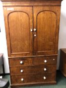 A VICTORIAN PINE LINEN PRESS WITH ARCHED DOORS ENCLOSING FOUR SLIDES OVER A FIVE DRAWER CHEST. W 128