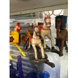 A COLLECTION OF PAINTED WOOD HORSES, OTHER ANIMALS, A CART, A COT, ETC.