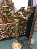 A GOLD DECORATED CAST IRON CANDELABRA OF LARGE PROPORTIONS.