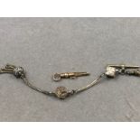 A VICTORIAN POCKET WATCH RATCHET KEY TOGETHER WITH A VICTORIAN POCKET WATCH CHAIN AND TASSEL.