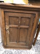 AN OAK COSTWOLDS SCHOOL ARTS AND CRAFTS SMALL CORNER CABINET.